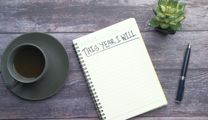 Closeup of a notebook on a table with New Year resolution goals