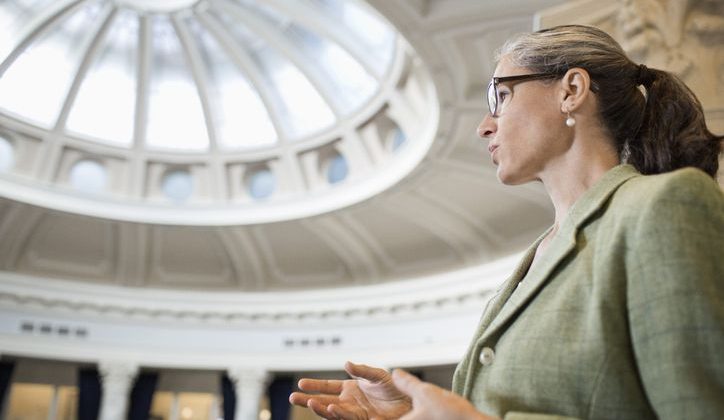 Caucasian woman talking in a government building