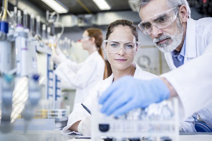 Scientists in lab examining samples