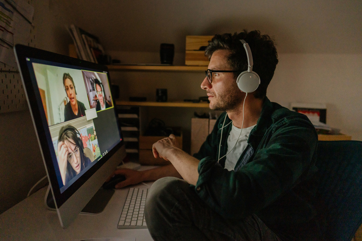 Man having a video conference call with his colleagues at home