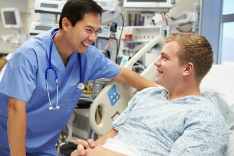 Young Male Patient Talking To Male Nurse In Emergency Room