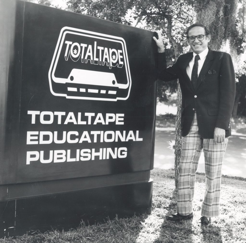 Nathan Bisk in front of Total Tape sign, the name of the company before he changed it to Bisk Education