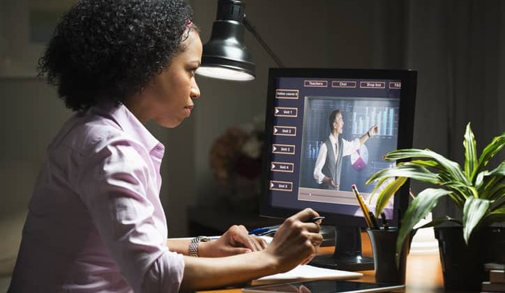 Mixed-race businesswoman taking an online class on a laptop
