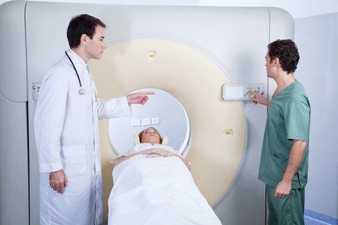 Doctor giving instructions to technician for carrying out MRI sc